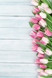 Fototapeta Tulipany - Pink tulips over wooden background