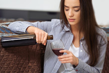 Depressed Woman Drinking Wine Indoors