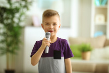 Cute Little Boy With Microphone At Home