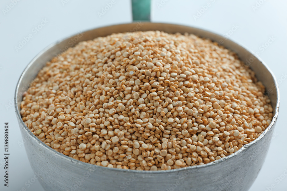 Organic quinoa seeds in pan, closeup