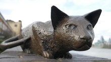 Iron Statue Of A Cat On A Brick Fence.