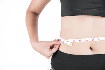 young woman hand holding measuring her thin waist with a tape measure