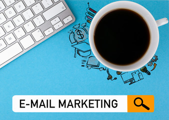Wall Mural - e-mail marketing concept. Coffee mug and computer keyboard on a blue background.