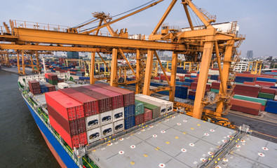 container ship in import export and business logistic.By crane ,Trade Port , Shipping.cargo to harbor.Aerial view.Top view.