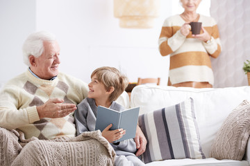 Wall Mural - Grandson reading book with grandfather