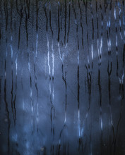 Dark Blue Rainy Window With Scary Pattern Of The Raindrops Paths