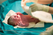 © taskin - Brand New Baby.Newborn baby girl getting checked by the doctor