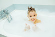 © alexeytsurkan - Happy young boy taking a bath. Smiling child washing in the foam and shows thumbs up.