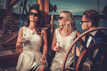 Wall Mural - Stylish wealthy friends having fun on a luxury yacht