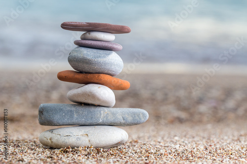 Naklejka - mata magnetyczna na lodówkę Pile of stacked stones on the sandy beach at Adriatic sea