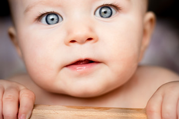 Surprised baby with beautiful blue eyes