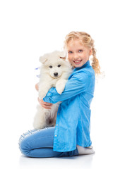 Wall Mural - Little girl with a samoyed puppy