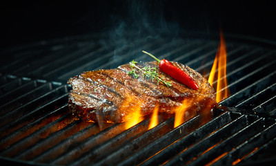 Wall Mural - Hot spicy chili steak grilling on a barbecue