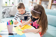 © leszekglasner - Brother and sister drawing with colorful pencils at home