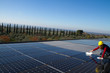 © franco lucato - young woman cleaning photovoltaic panels