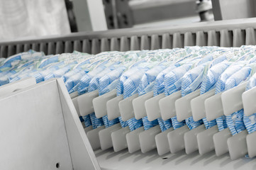 Wall Mural - diapers on a conveyor belt closeup. factory and equipment for the production of pampers