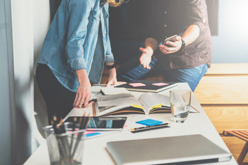 Wall Mural - Meet one-on-one.Business meeting. Teamwork.Man showing woman information on smartphone screen.