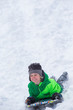 © Colin - Boy riding a sled tobogganing in the snow