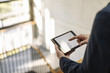 © Westend61 - Businessman using tablet in staircase