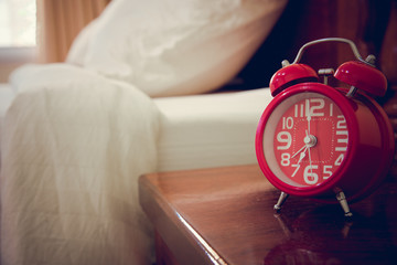 Red alarm clock in bedroom.