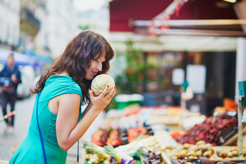 Wall Mural - French woman choosing fruits on market