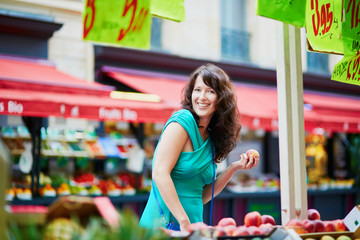 Wall Mural - French woman choosing fruits on market