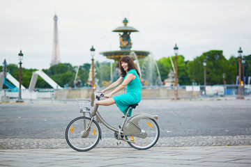 Wall Mural - Woman riding a bicycle on a street of Paris