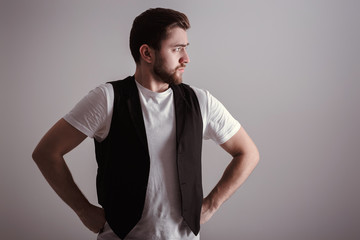 Wall Mural - portrait of handsome young serious man in white shirt on gray background