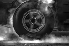 Drag Racing Car Metal Wheel Burns Rubber Off Its Tyre In Preparation For The Race.