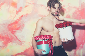 Wall Mural - bearded muscular man with sexy body holds red rose box