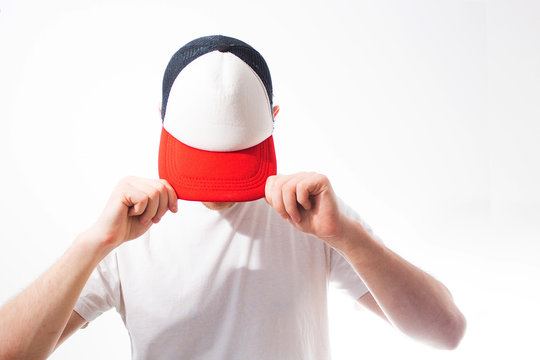 Fototapete - the man, guy in the blank white, red baseball cap,  on a white background, mock up, free space, logo presentation , template for print,  design, empty