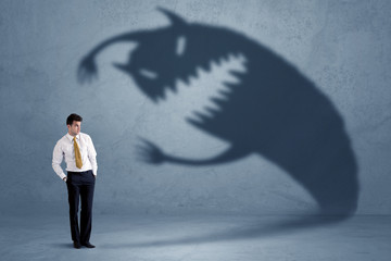 Wall Mural - Business man afraid of his own shadow monster concept