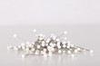 Pile of white strait pins isolated on a white background.