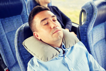 Poster - man sleeping in travel bus with cervical pillow