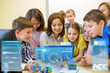 © Syda Productions - group of kids with teacher and tablet pc at school