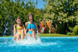 © Iuliia Sokolovska - Summer fitness, kids in swimming pool have fun, smiling girls splash in water, children on family vacation