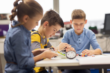 Wall Mural - happy children building robots at robotics school