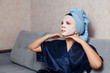 © Parilov - The girl applies and corrects the nourishing mask on the skin. Mask for rejuvenating and eliminating skin defects. Acne, acne.