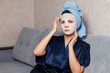 © Parilov - The girl applies and corrects the nourishing mask on the skin. Mask for rejuvenating and eliminating skin defects. Acne, acne.