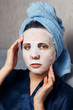 © Parilov - The girl applies and corrects the nourishing mask on the skin. Mask for rejuvenating and eliminating skin defects. Acne, acne.