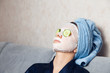 © Parilov - The girl puts and corrects a nutritious mask on a skin with green ripe fresh cucumber. Mask for rejuvenating and eliminating skin defects. Acne, acne.