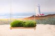 A newborn background backdrop with moss on a swing over a sandy beach with a lighthouse and ocean waves in the background.