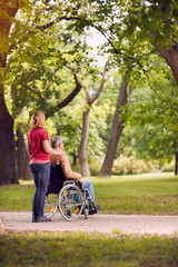 Wall Mural - enjoying senior man in wheelchair and daughter in the park .