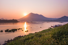 Grass Flowers With Sunset Background Of Mountains And Rivers At Loei Province, Thailand.