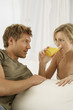 © STOCK4B  - Couple looking at each other, woman drinking orange juice