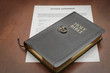 wedding rings on a bible and divorce papers