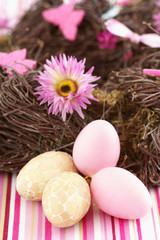  Easter eggs next to a nest, close-up, selective focus