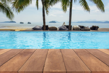 Blue swimming pool summer vacation and wooden deck