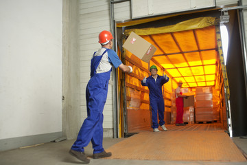 Two men throwing a packet