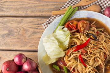 Wall Mural - Papaya salad on wood table. Papaya salad  has a name that Thai people called 